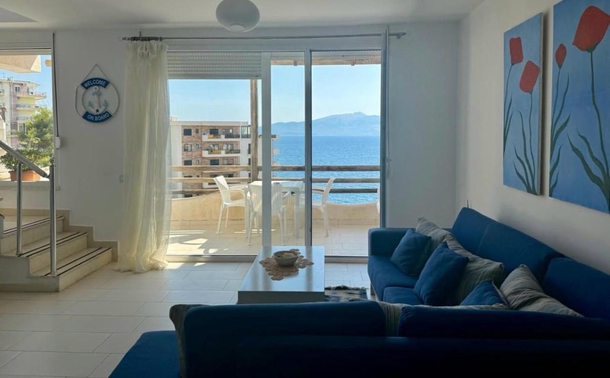 Duplex living room opening to a sea-view terrace