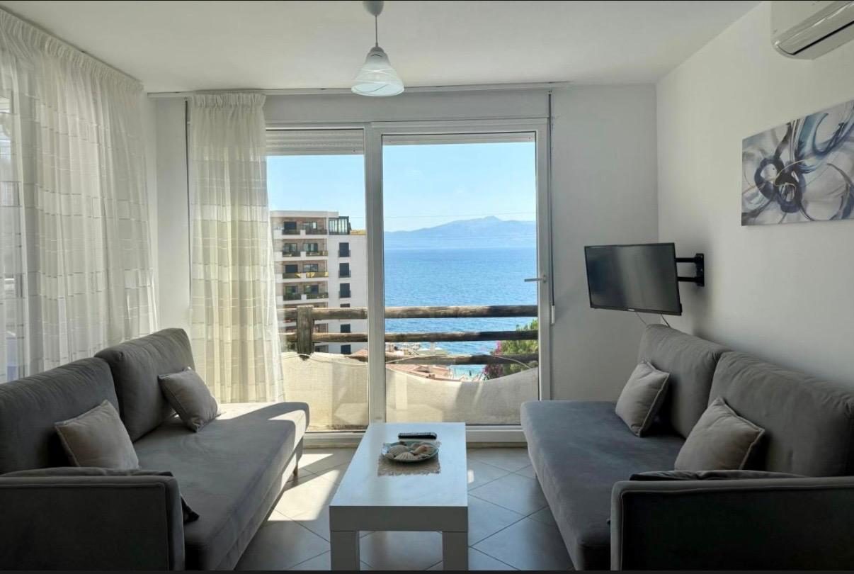 Living room with grey sofas and sea view balcony