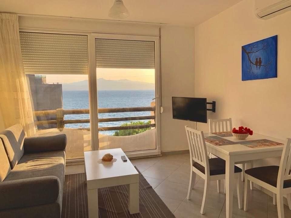 Living room with balcony overlooking the sea at sunset
